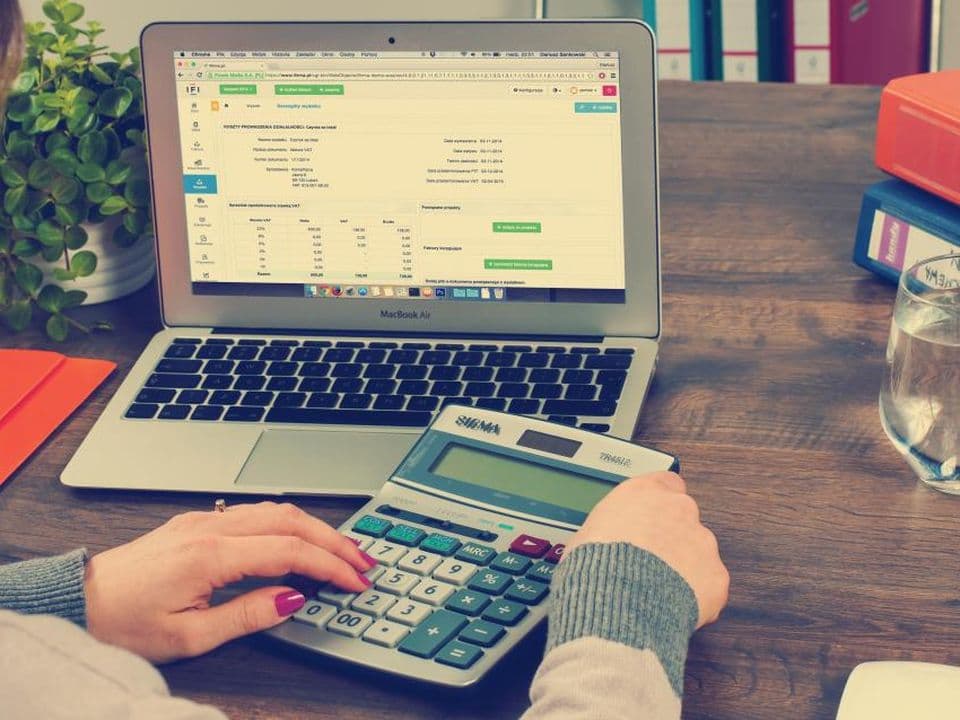 A spreadsheet printout next to a calculator